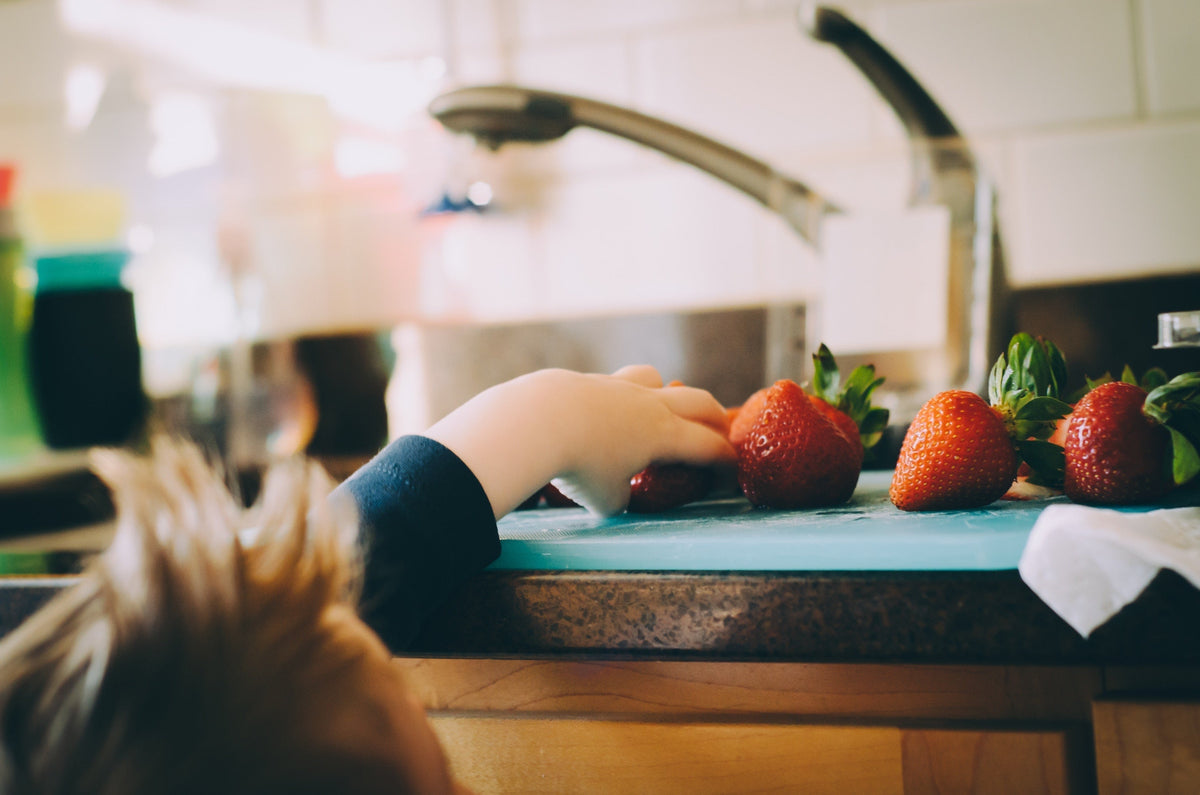 Kid picking strawberry